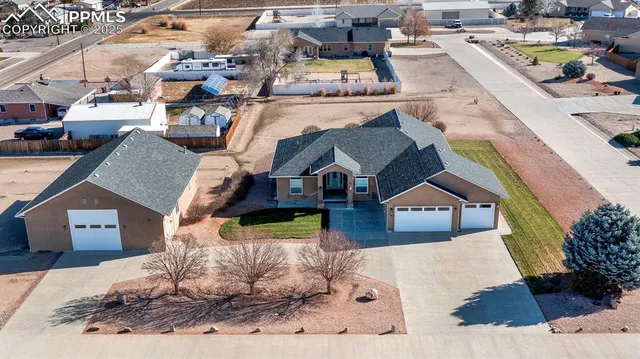 an aerial view of a house with a yard