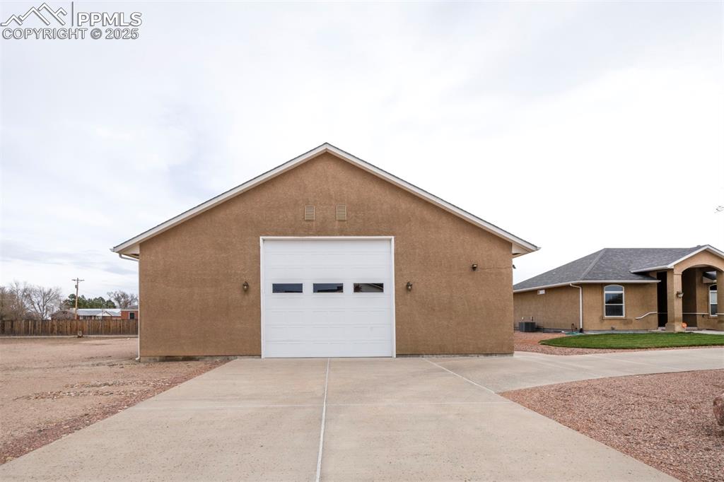 24484 Gale Road Pueblo, CO 81006 - Photo 5 of 43 a front view of a house with a yard and garage