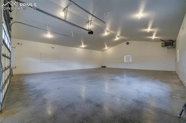 an empty room with projector and screen