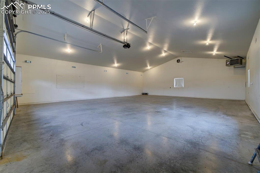 24484 Gale Road Pueblo, CO 81006 - Photo 6 of 43 an empty room with projector and screen