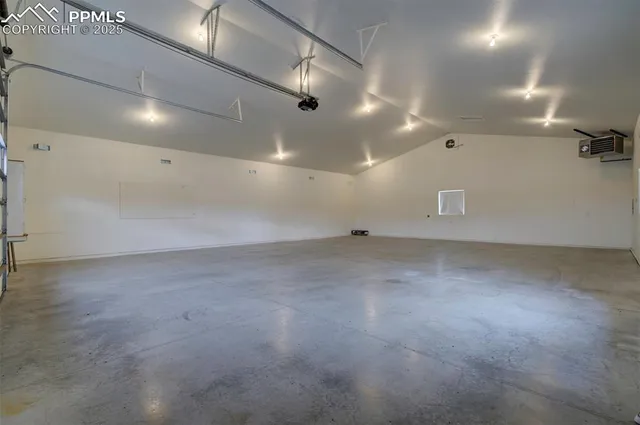 an empty room with projector and screen