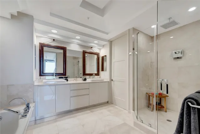 a large bathroom with a double vanity sink toilet mirror and bathtub