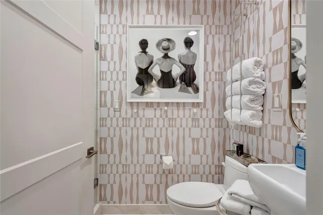 a white toilet sitting next to a shower curtain