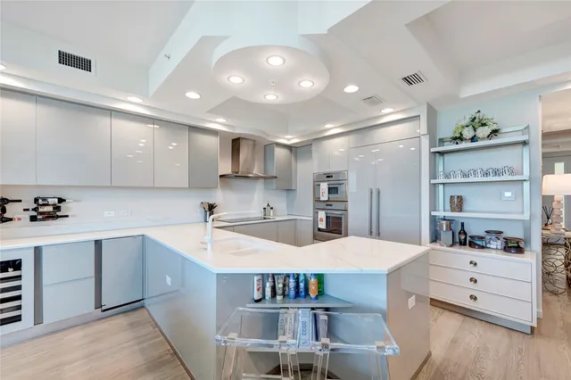 a kitchen with stainless steel appliances kitchen island granite countertop a sink and cabinets
