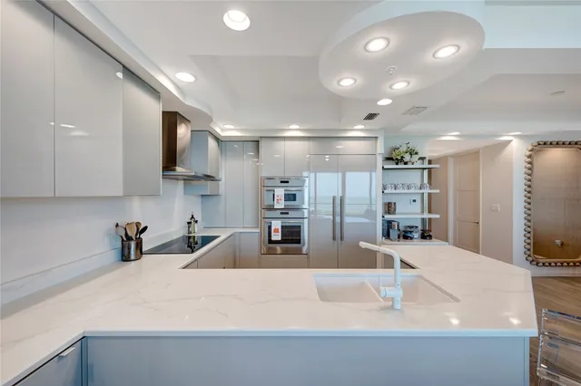 a large kitchen with stainless steel appliances