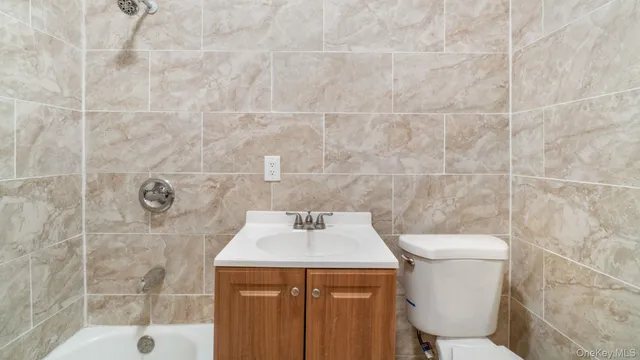 a bathroom with a sink a toilet and a shower