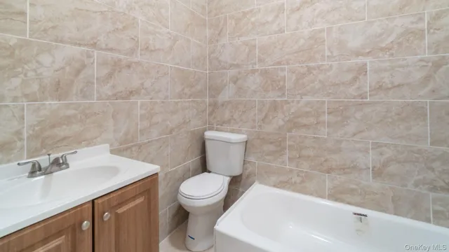 a white toilet sitting next to a bathroom sink