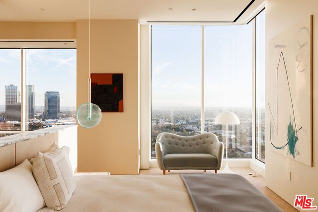 a bedroom with furniture and large windows