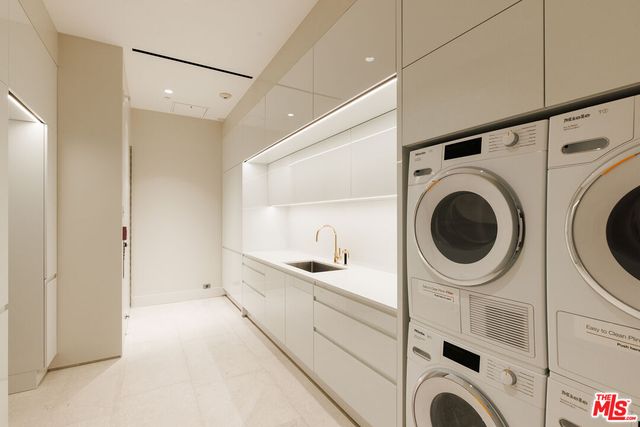 a bathroom with a sink a washer and dryer