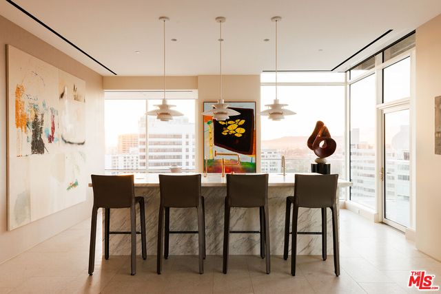 a view of a kitchen with dining table and chairs