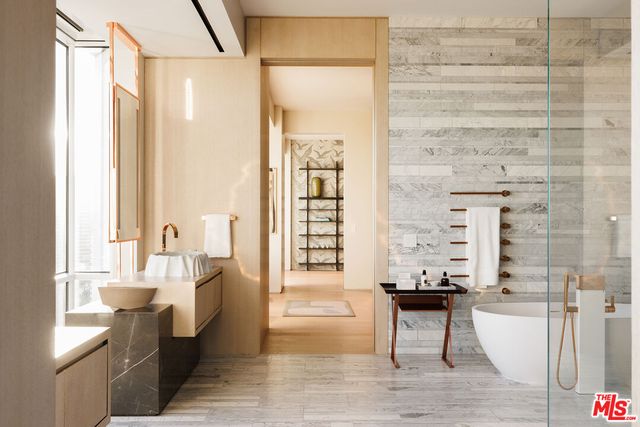 a living room with furniture a wooden floor and a large window