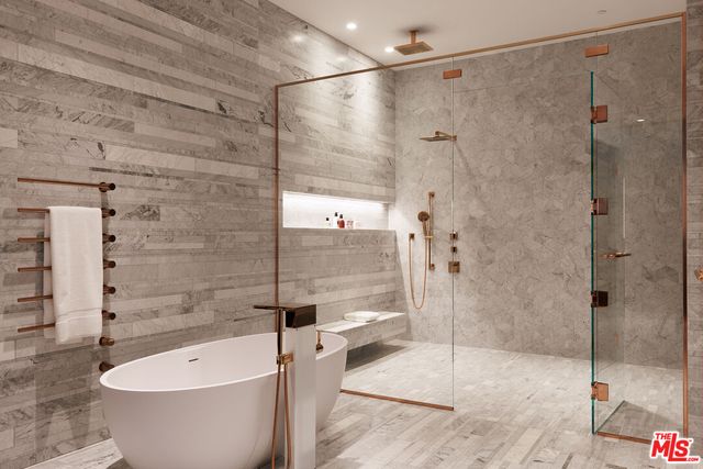 a bathroom with a white bath tub and shower