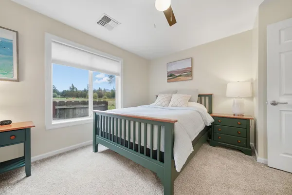a spacious bedroom with a bed and a window