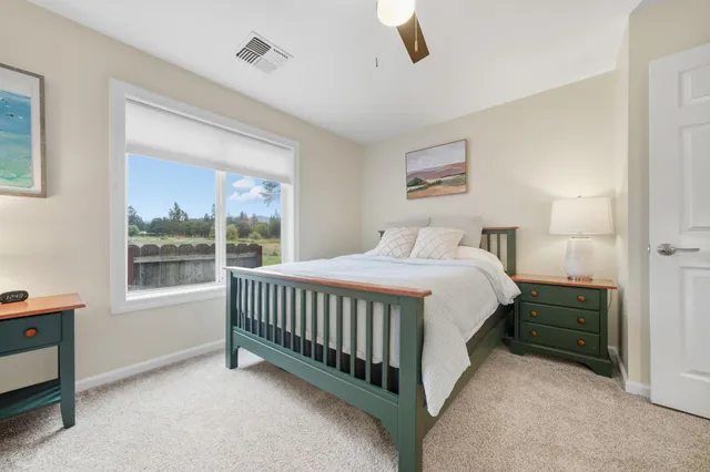 a spacious bedroom with a bed and a window
