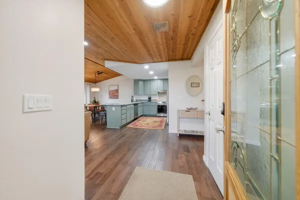 a view of a kitchen with cabinets and wooden floor