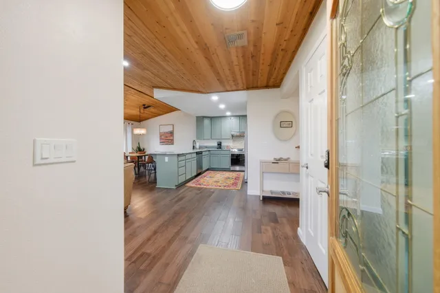a view of a kitchen with cabinets and wooden floor