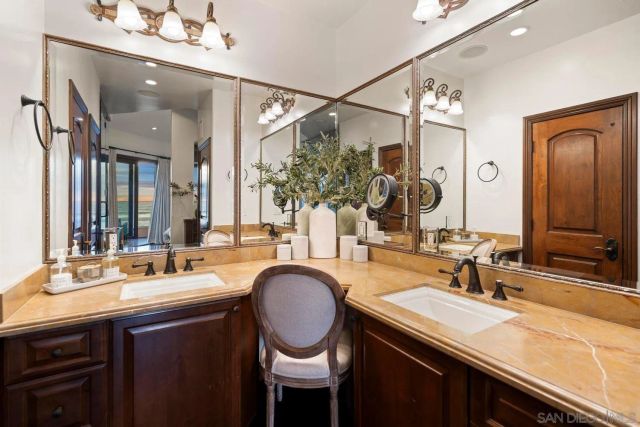 a bathroom with a sink double vanity and a mirror