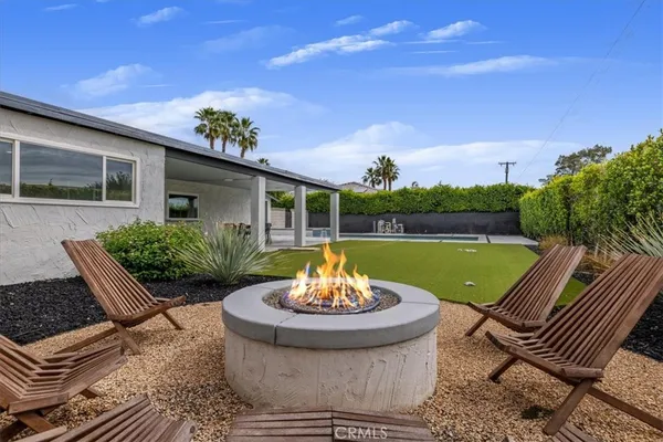 a view of a house with a yard porch and sitting area
