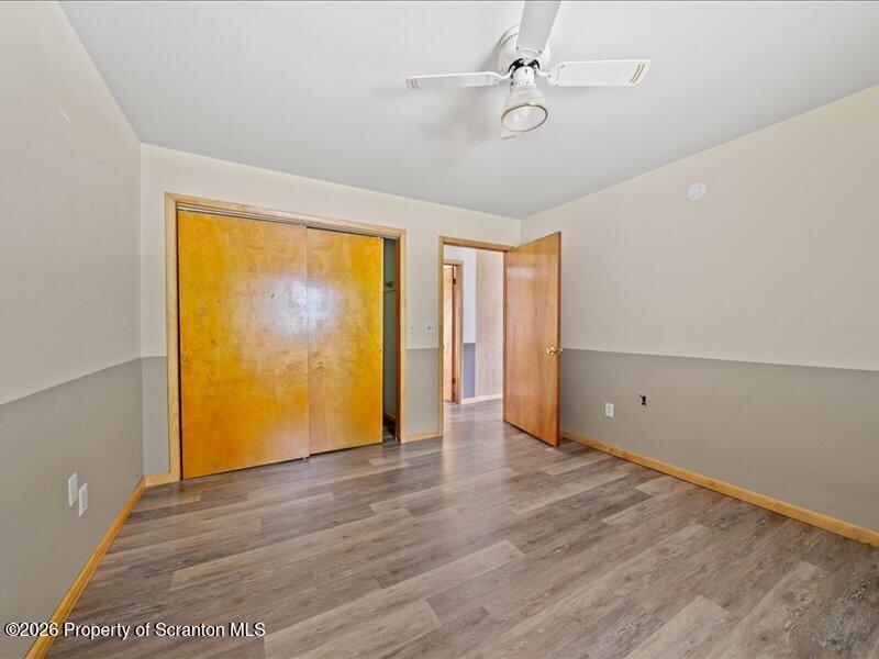 9-17 Vago Road Tunkhannock, PA 18657 - Photo 19 of 57 an empty room with wooden floor and windows