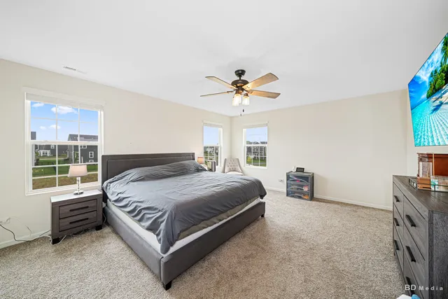 a bedroom with a bed and a chandelier