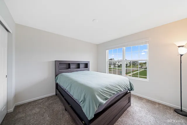 a bedroom with a bed and window
