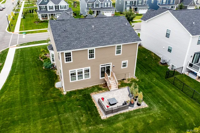 an aerial view of a house with a yard