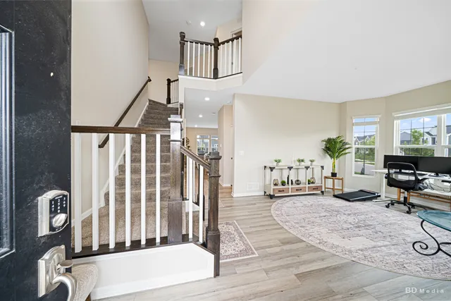a living room with furniture a chandelier and wooden floor