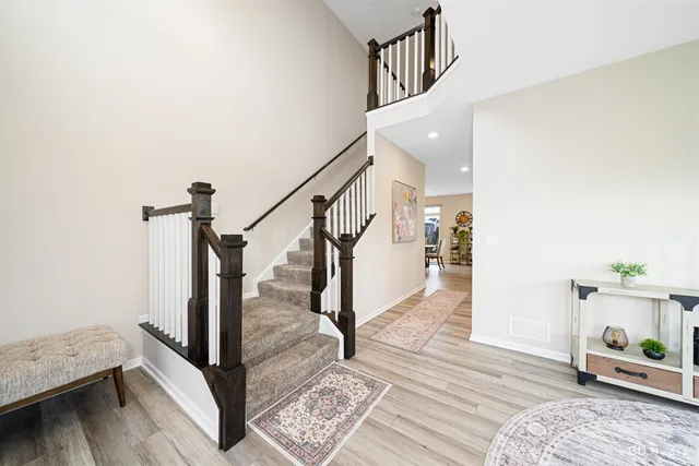 a view of entryway and hall with wooden floor