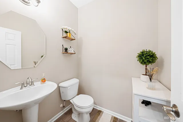 a bathroom with a sink toilet and a mirror