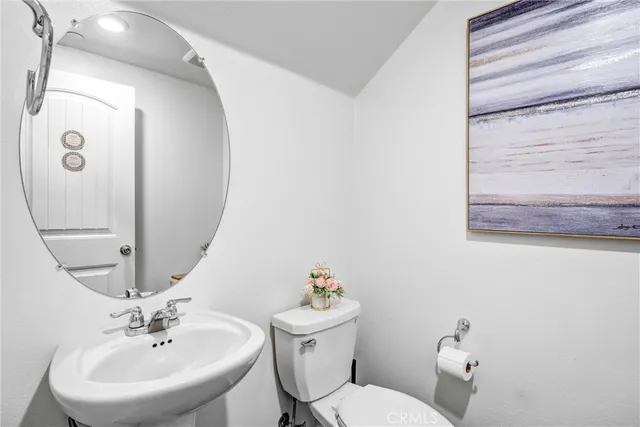 a bathroom with a sink mirror and toilet