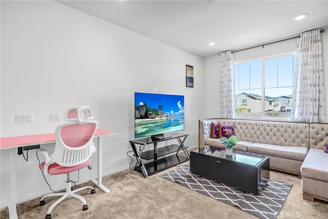 a living room with furniture a rug and a window