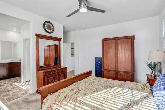 a bedroom with a bed and a television