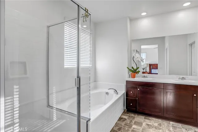 a bathroom with a bathtub sink and mirror