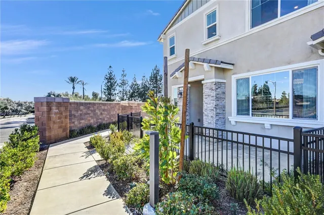a view of a pathway of a house with a flower garden