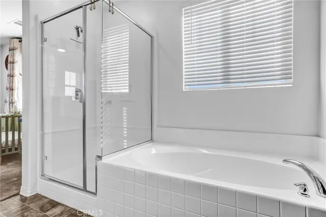 a bathroom with a bathtub and a shower