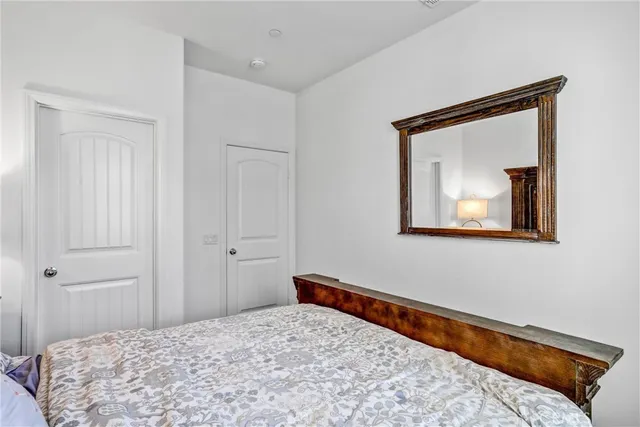 a bedroom with a bed and a painting on the wall