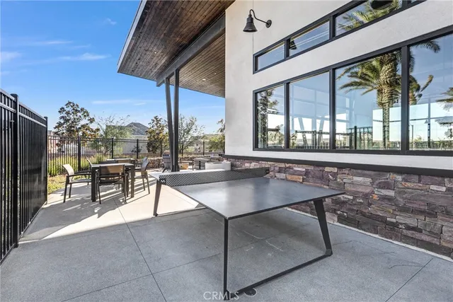 a view of a patio with a table and chairs