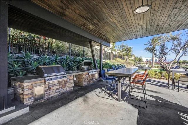 a view of a patio with table and chairs potted plants with floor to ceiling window