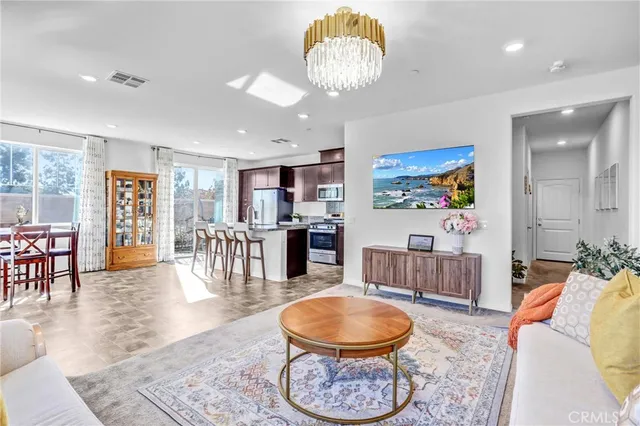 a living room with furniture a rug and a chandelier