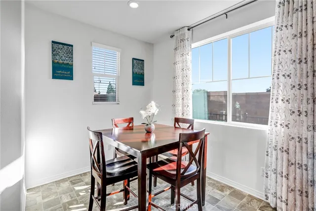 a dining room with furniture and window
