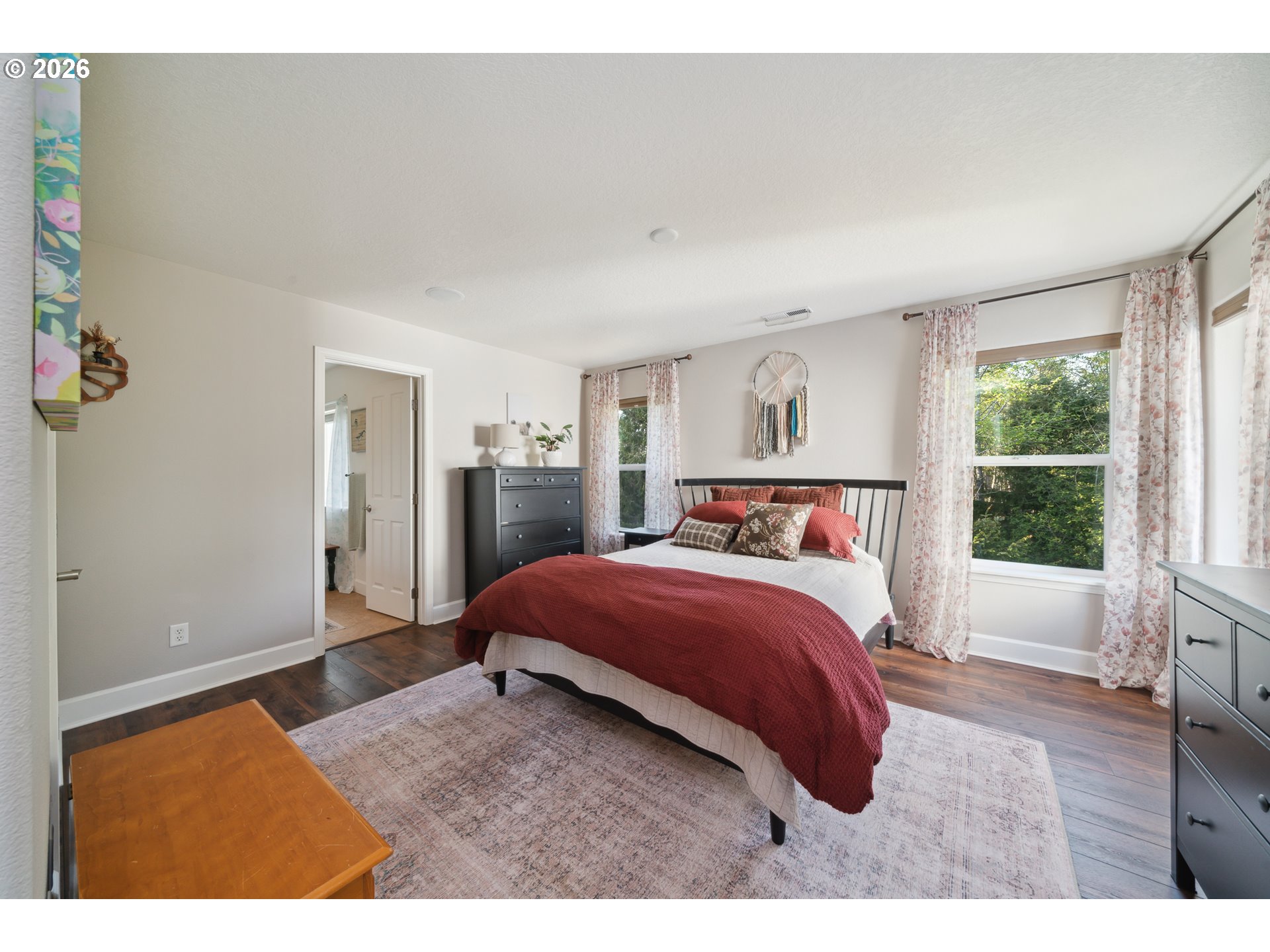 4300 Sequoia Loop Netarts, OR 97141 - Photo 24 of 39 a bedroom with a large bed and wooden floor
