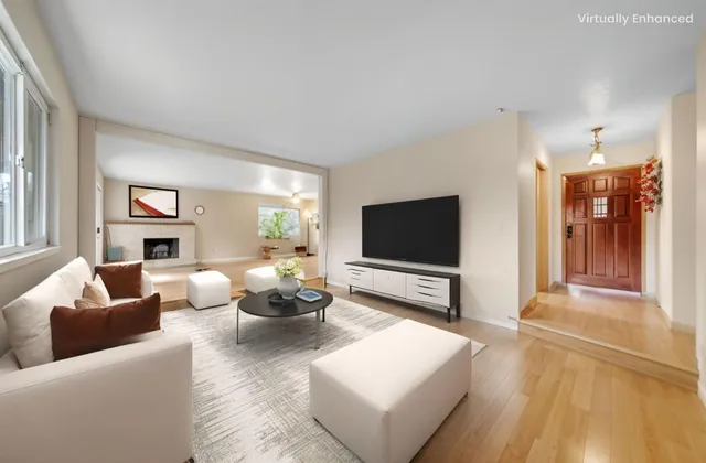 a living room with fireplace furniture and a flat screen tv