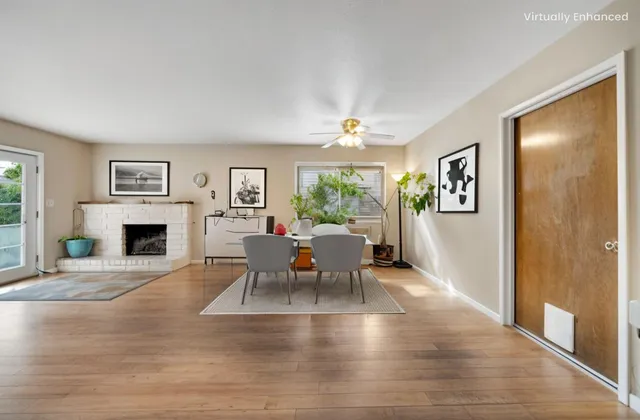 a living room with furniture two window and a fireplace