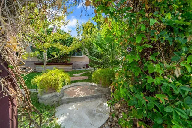 a backyard of a house with a yard and outdoor seating
