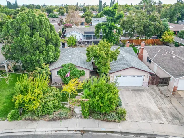 an aerial view of a house with a yard and garden