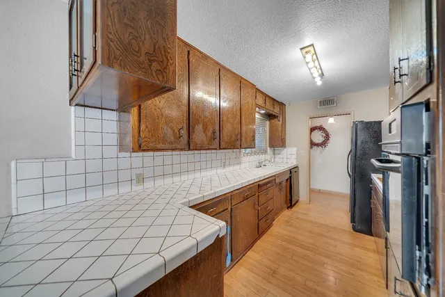 a kitchen with stainless steel appliances granite countertop a sink and a stove