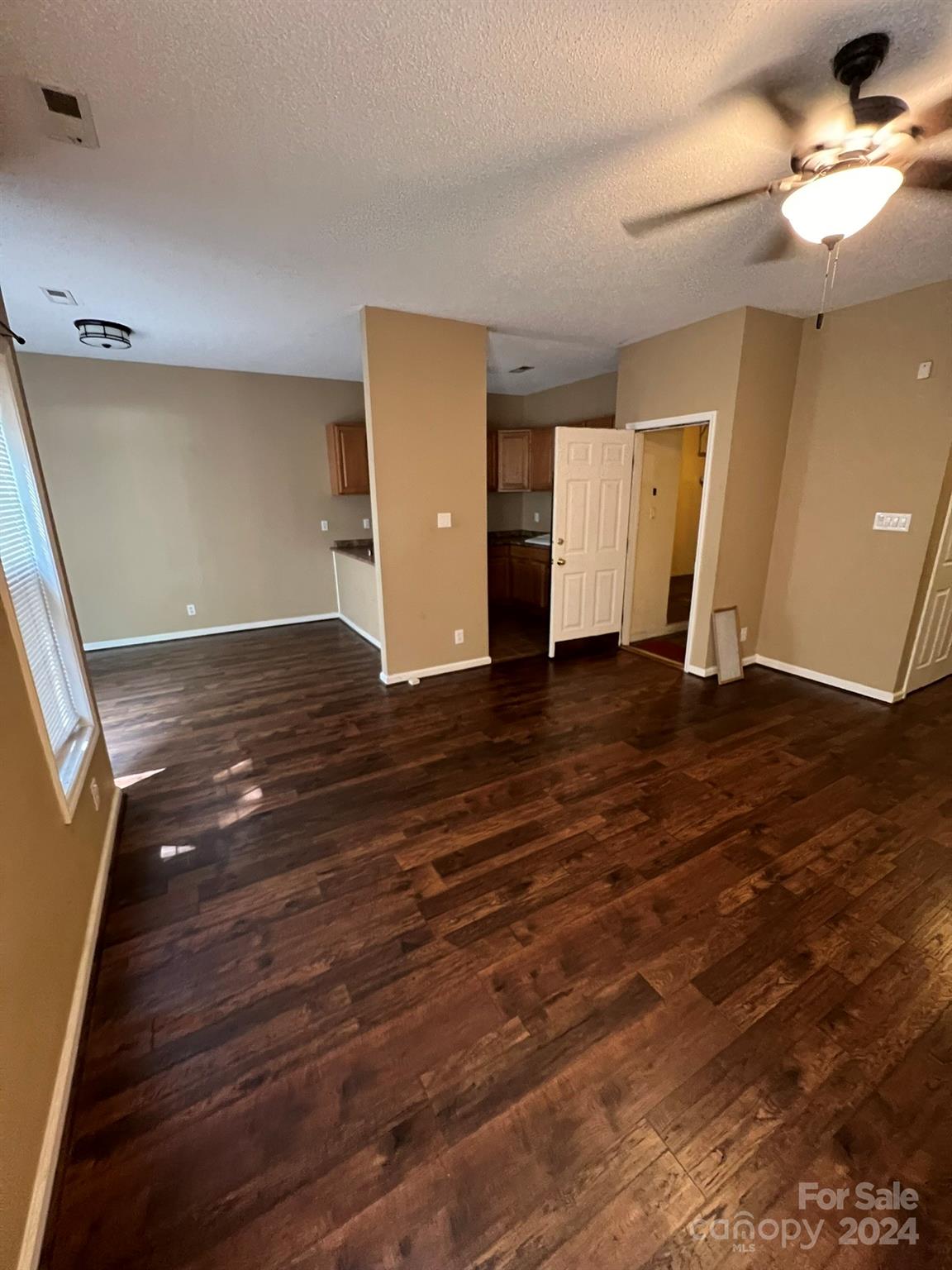 4124 Beaufain Street Raleigh, NC 27604 - Photo 10 of 12 a view of an empty room with window and wooden floor