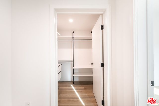 a bathroom with a walk in closet and a window