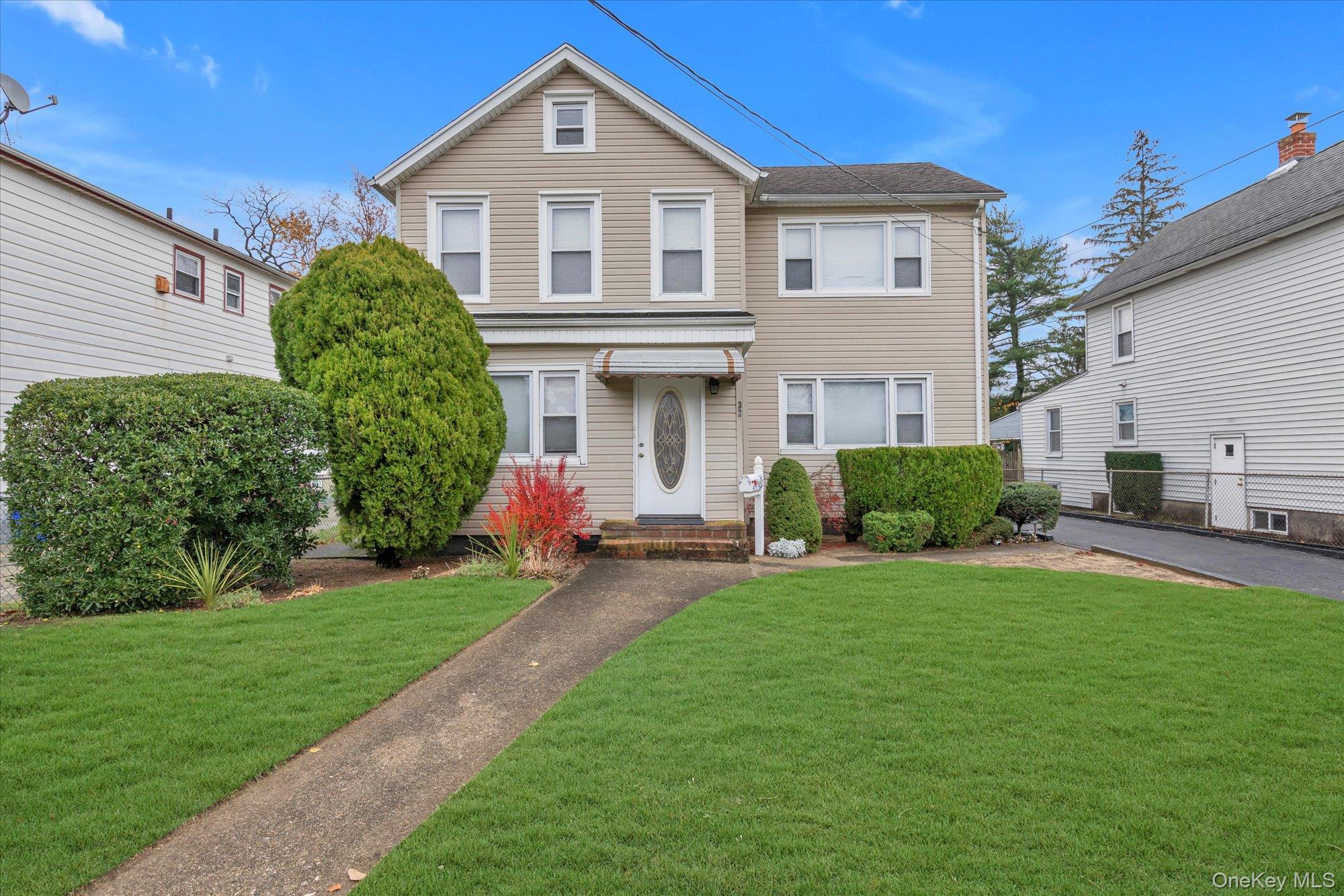 a front view of a house with a yard and garage