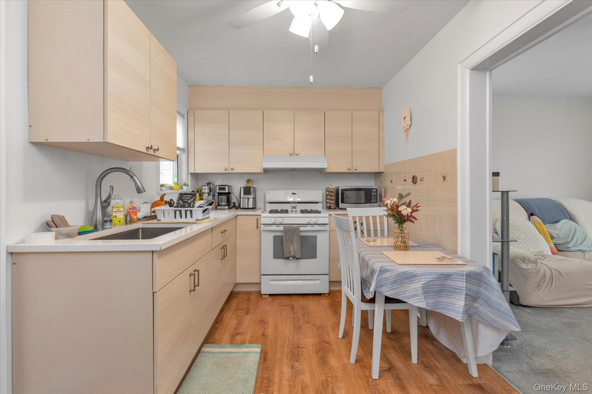 32 5th Street Valley Stream, NY 11581 - Photo 11 of 23 a kitchen with stainless steel appliances granite countertop a white cabinets and a stove top oven
